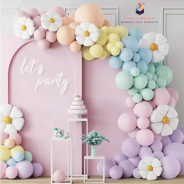 Child next to a pastel daisy balloon arch